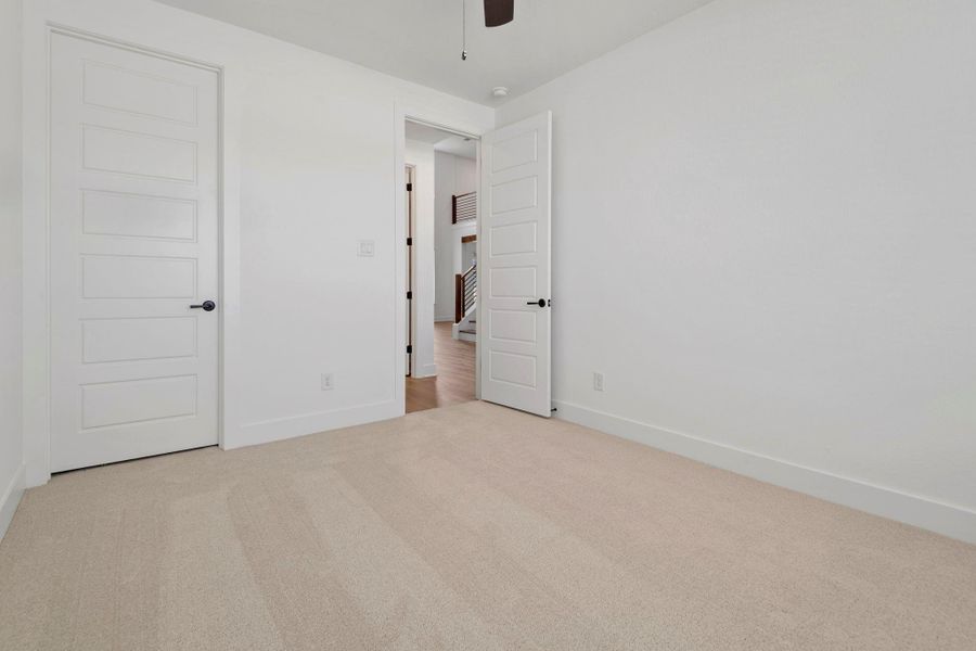 A secondary bedroom located downstairs.