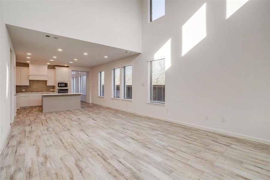 Large living room featuring 19 ft ceilings and tons of natural light