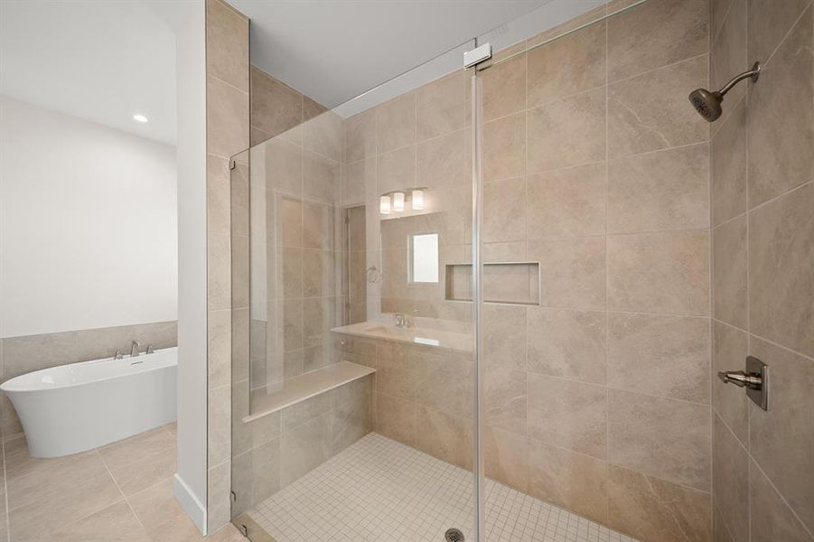 Bathroom with a freestanding bath, a shower stall, tile patterned flooring, and recessed lighting