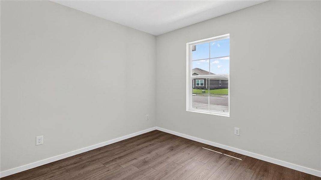 Neutral wall color with wood-finish flooring