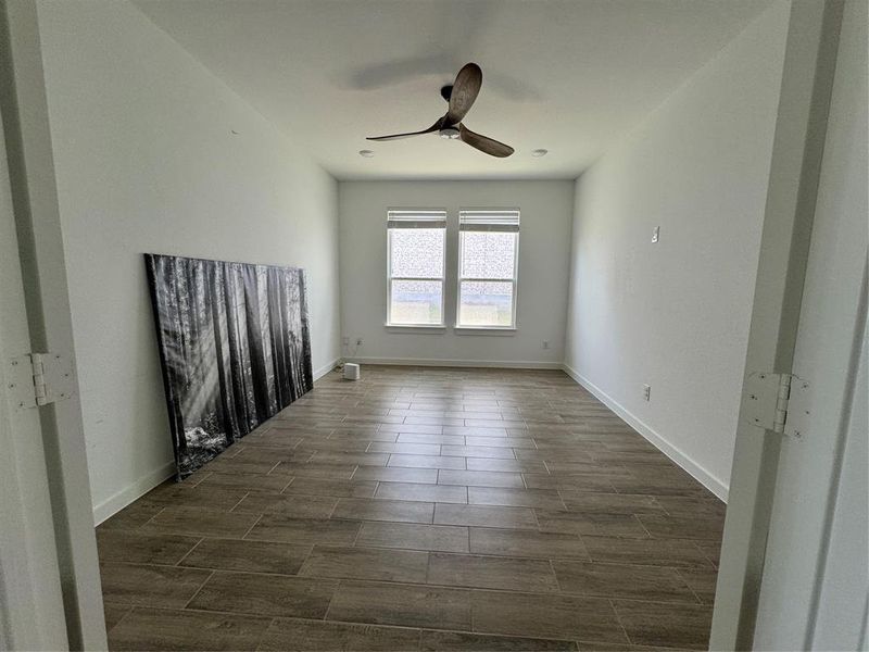 Unfurnished room featuring wood finish floors and ceiling fan Unfurnished room featuring wood finish floors and ceiling fan