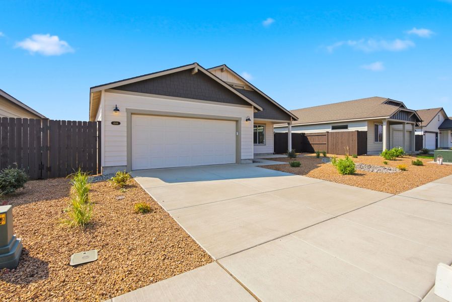 Front exterior of a new home in Feather Ridge, Redmond, OR, highlighting curb appeal (Image 25).
