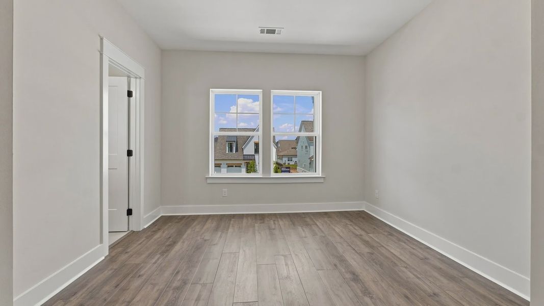 Secondary Bedroom with hard surface flooring and windows