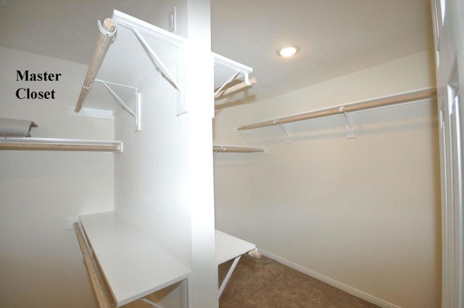 Plenty of hanging space in this double compartment master closet.