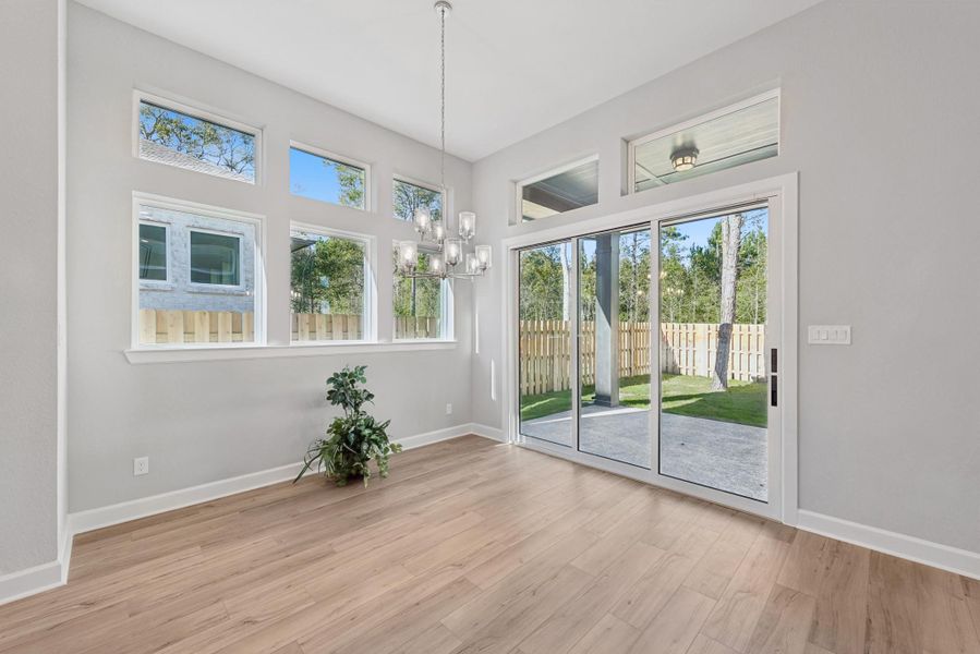 Large Dining area that is surrounded by windows including a stacking sliding glass door Large Dining area that is surrounded by windows including a stacking sliding glass door