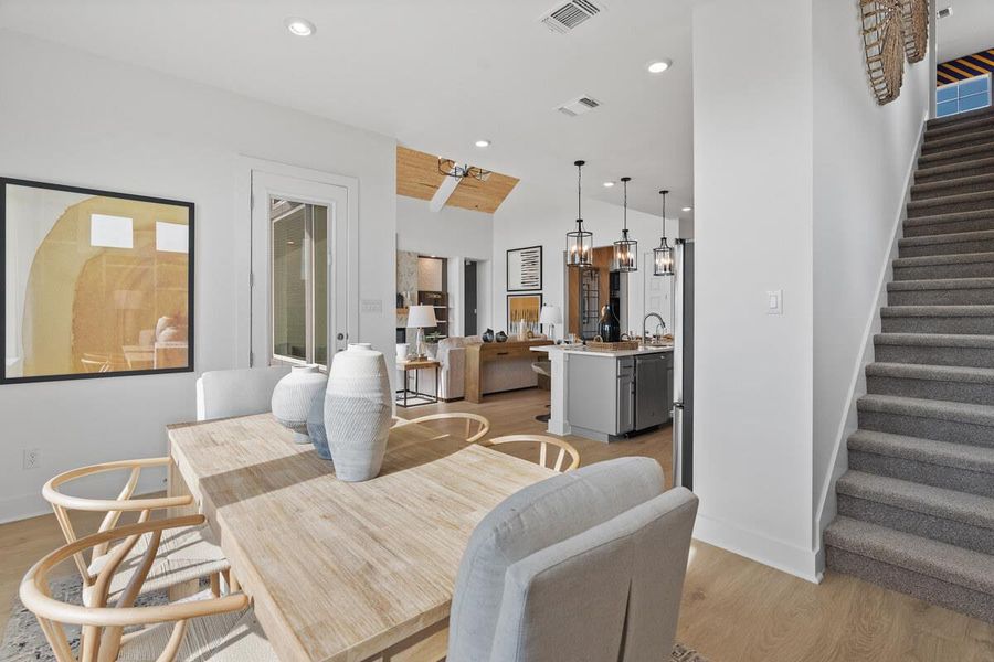 Dining space with light wood-style floors and recessed lighting