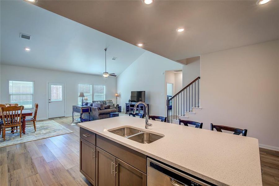 Kitchen featuring light wood-type flooring, sink, a wealth of natural light, and vaulted ceiling