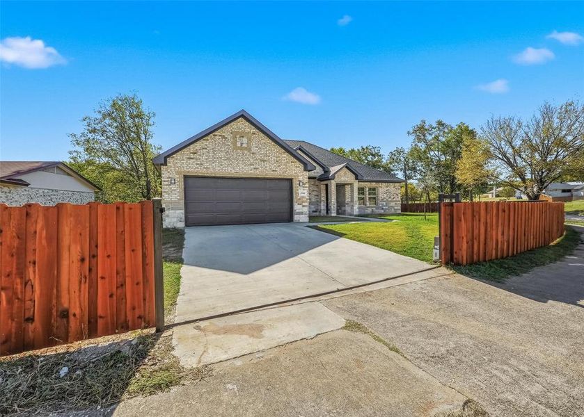 French country inspired facade with brick siding, driveway, and a garage French country inspired facade with brick siding, driveway, and a garage