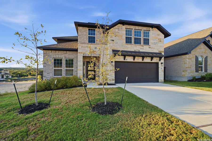Front exterior of a new home in The Woodlands at Medina Hills, Mico, TX, highlighting curb appeal (Image 23).