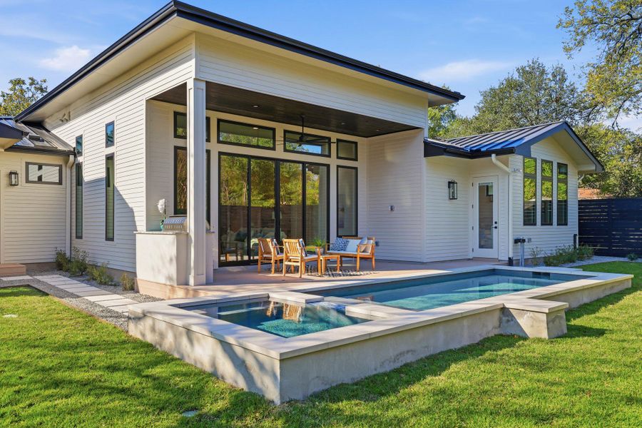 Back of house with a lawn and a patio area