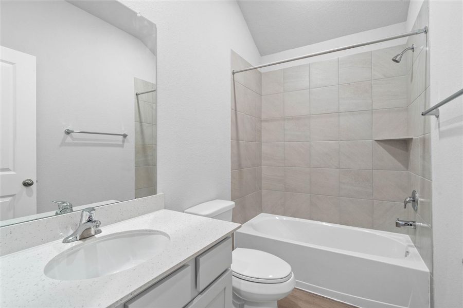 A streamlined secondary bathroom providing a functional tub/shower combination and modern fixtures, seamlessly blending practicality and style.