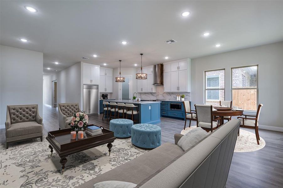 Virtually staged for illustrative purposes only. Living room featuring an inviting chandelier, light hardwood / wood-style flooring, and sink