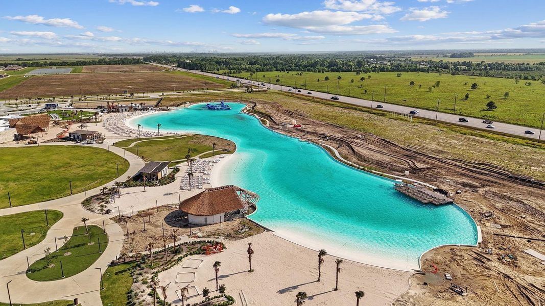 Experience resort-style living every day with this breathtaking crystal-clear lagoon! Enjoy white sand beaches, shaded lounging areas, and scenic walking paths—all within your own neighborhood. A true destination right at home.