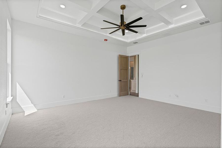 Spare room featuring coffered ceiling, carpet floors, beamed ceiling, a ceiling fan, and recessed lighting Spare room featuring coffered ceiling, carpet floors, beamed ceiling, a ceiling fan, and recessed lighting