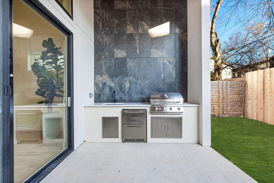 View of patio with area for grilling and sink