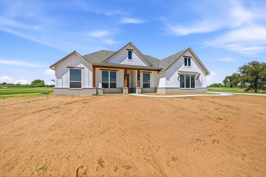 Front exterior of a new home in Zion Valley, Poolville, TX, highlighting curb appeal (Image 16).