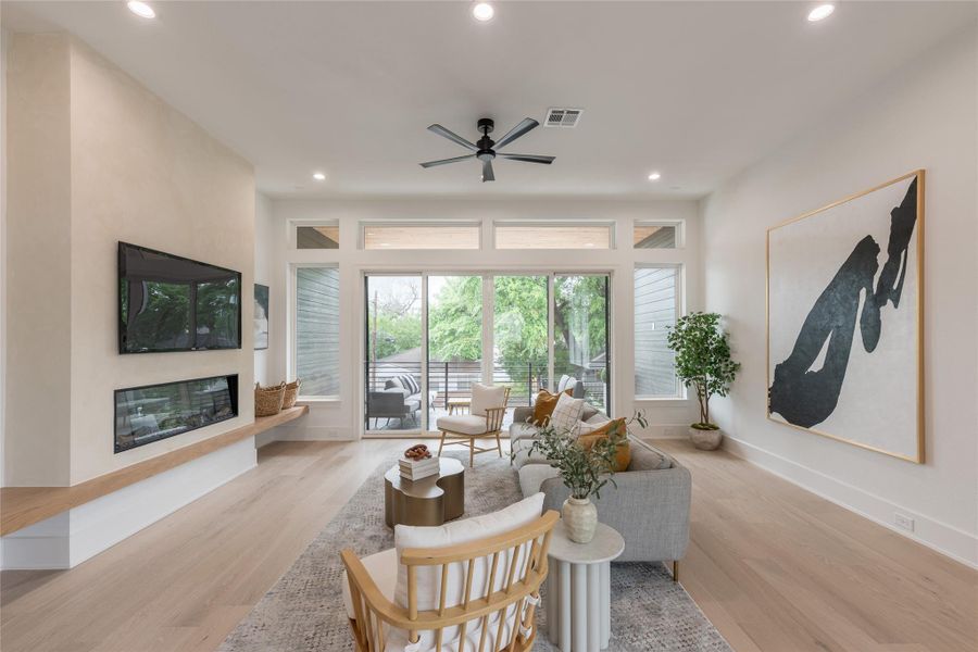 Mornings with the doors open. Afternoons with the fan on low. Evenings lit only by the linear flame and whatever's left of the western sky. This is the room that sells the house, and it's been designed to do exactly that.