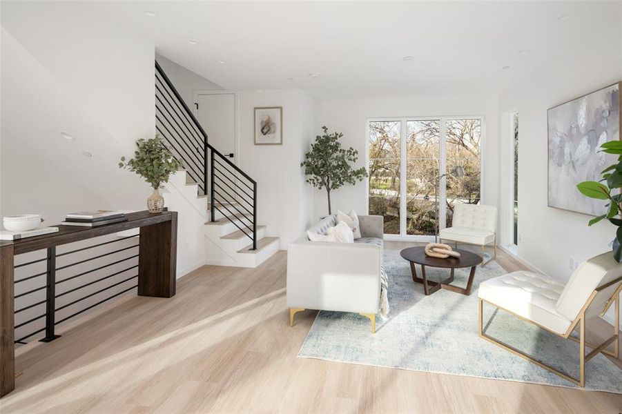 Sitting room with stairs and wood finished floors
