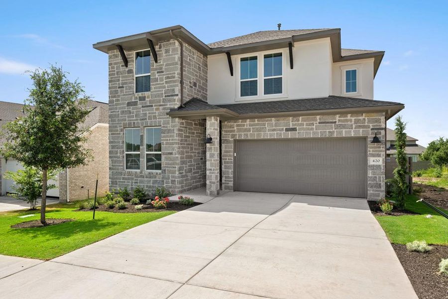 Front exterior of a new home in Wolf Ranch, Georgetown, TX, highlighting curb appeal (Image 2). Front exterior of a new home in Wolf Ranch, Georgetown, TX, highlighting curb appeal (Image 2).