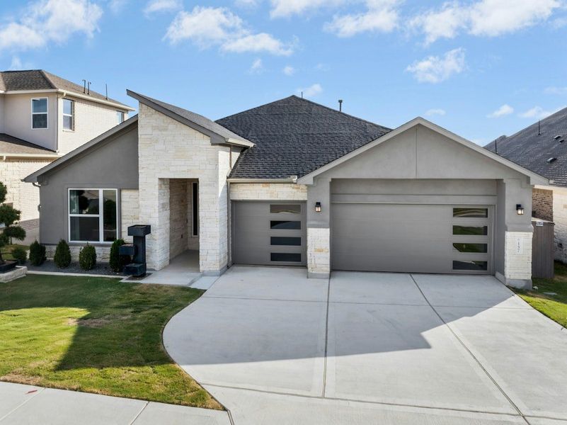 Front exterior of a new home in Anthem, Kyle, TX, highlighting curb appeal (Image 21).