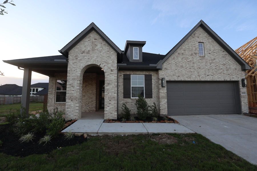 Front exterior of a new home in Brookewater - Ascent Collection, Rosenberg, TX, highlighting curb appeal (Image 2). Front exterior of a new home in Brookewater - Ascent Collection, Rosenberg, TX, highlighting curb appeal (Image 2).