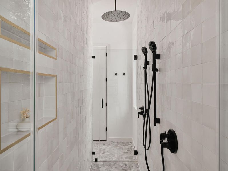 Modern shower enclosure featuring a rainfall showerhead, handheld shower, and matte black fixtures