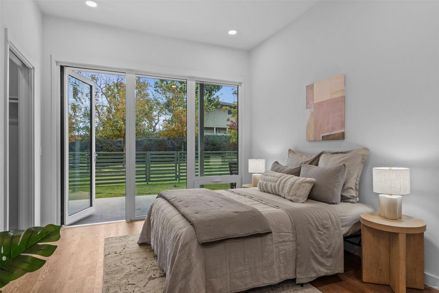 Bedroom featuring access to outside, wood finished floors, and recessed lighting