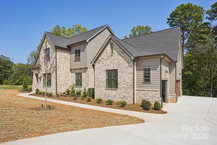 Front exterior of a new home in , Huntersville, NC, highlighting curb appeal (Image 26).