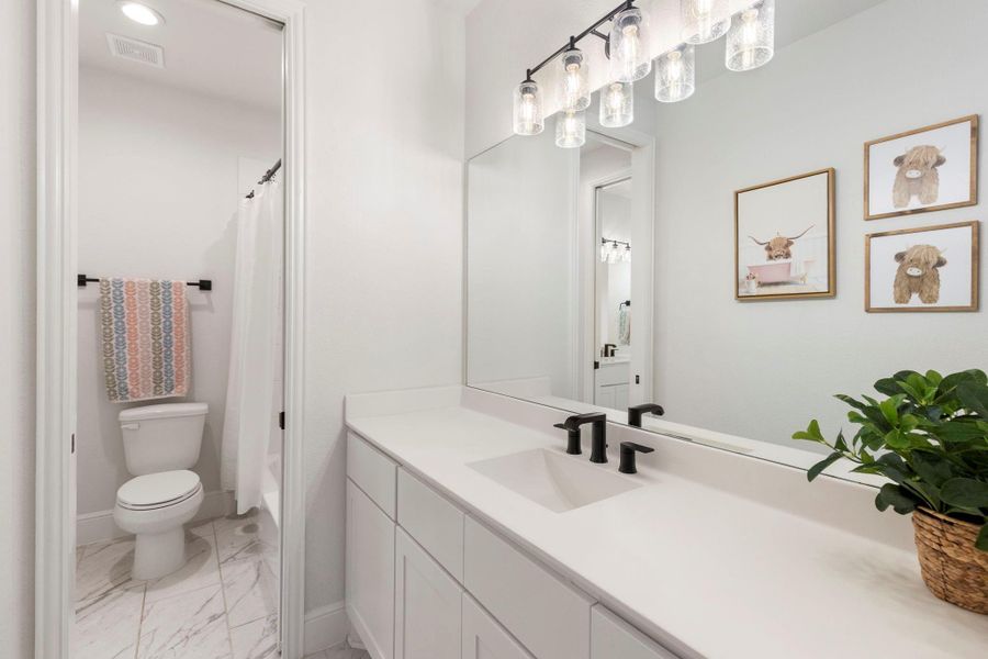 Secondary bedroom shares a Jack-n-Jill bath, each with their own vanity areas.