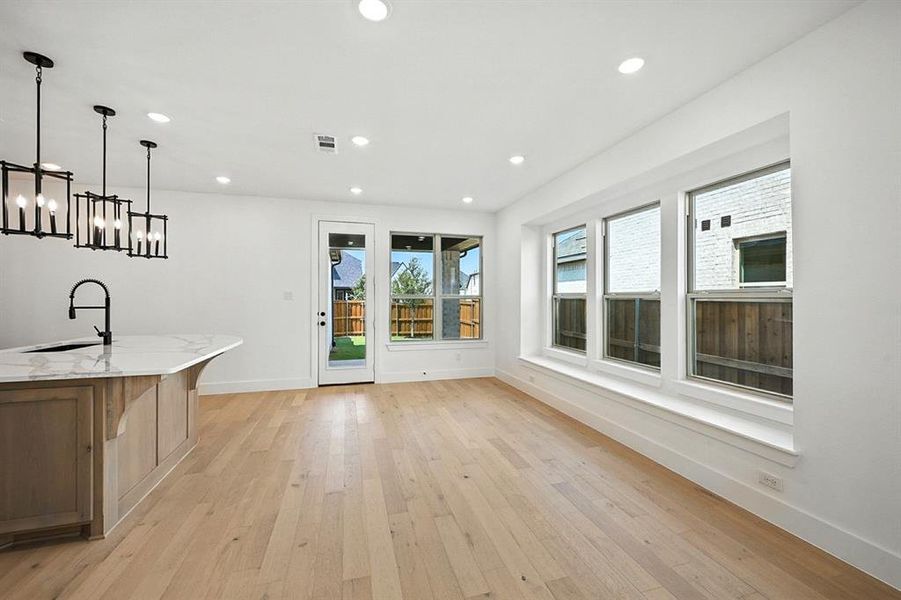 Unfurnished dining area featuring light wood-style floors and recessed lighting Unfurnished dining area featuring light wood-style floors and recessed lighting
