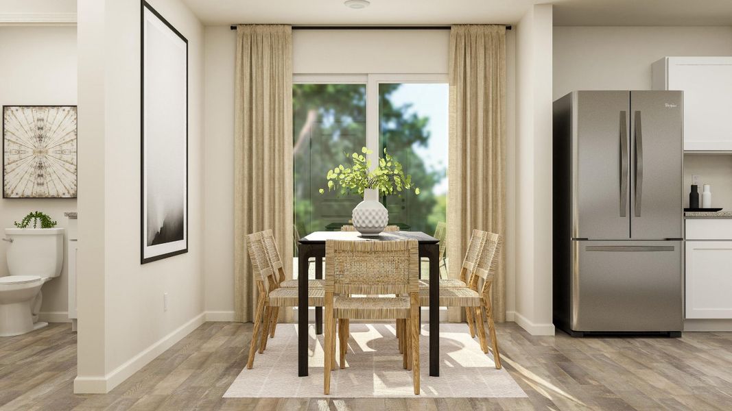 A kitchen with a dining table and chairs.