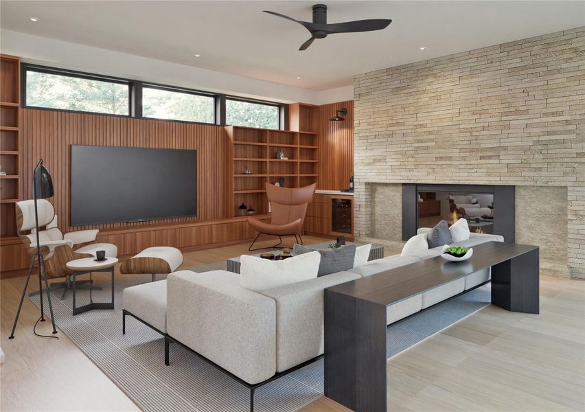 Living area with a fireplace, recessed lighting, wood finished floors, built in shelves, and a ceiling fan