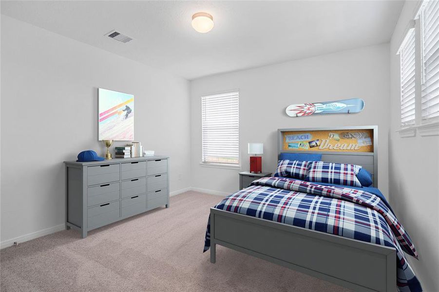 Secondary bedroom features plush carpet, neutral paint, lighting, windows with privacy blinds and ample sized closet space.