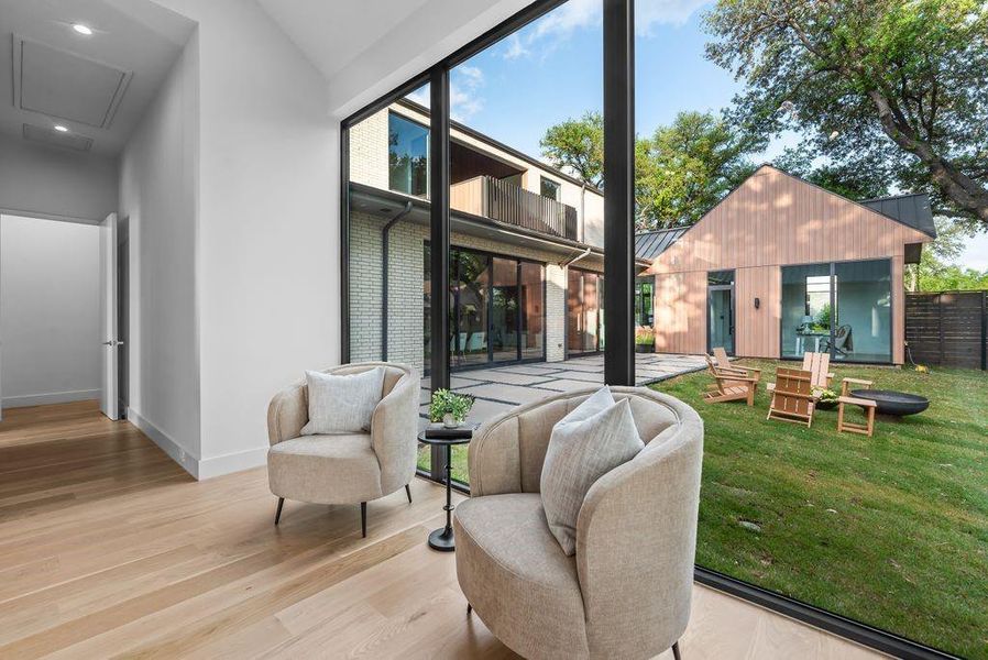 Expansive glass blurs the line between indoors and out, offering a true indoor-outdoor living experience from the privacy of the primary suite.