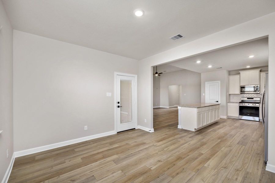 The dining room is adjacent to the kitchen and has access to the backyard.