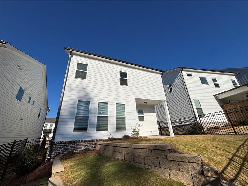Exterior details and patio area of a home in Palisades Single Family, Cumming (Image 2).