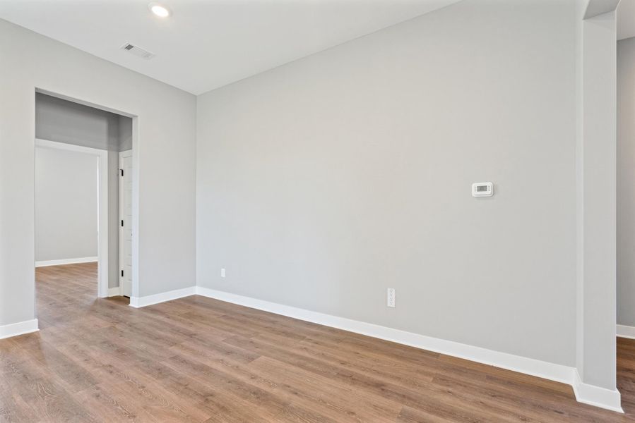Unfurnished room with light wood-type flooring and recessed lighting