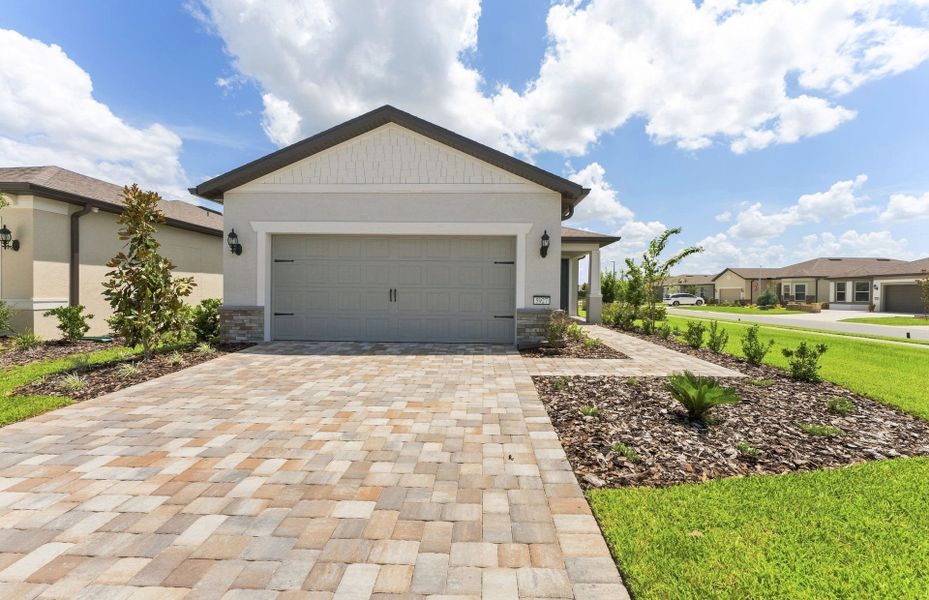Front exterior of a new home in Del Webb Stone Creek, Ocala, FL, highlighting curb appeal (Image 1). Front exterior of a new home in Del Webb Stone Creek, Ocala, FL, highlighting curb appeal (Image 1).