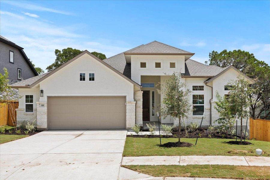View of front of home with stucco siding, roof with shingles, driveway, a garage, and stone siding View of front of home with stucco siding, roof with shingles, driveway, a garage, and stone siding