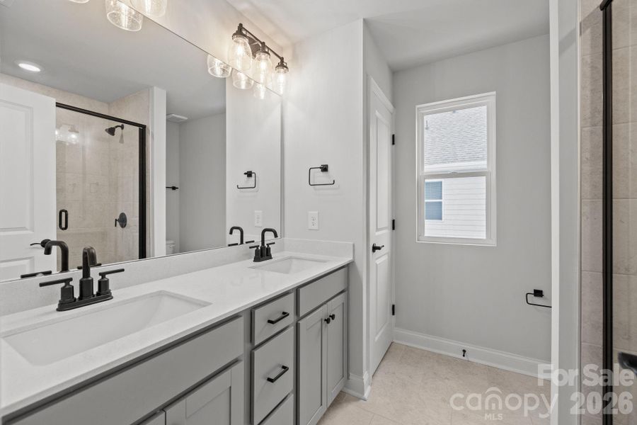Primary Bathroom with Linen Closet and walk in tiled shower