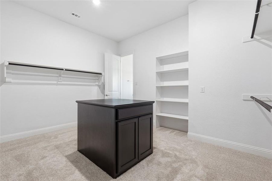Walk in closet featuring light carpet Walk in closet featuring light carpet