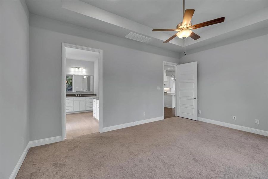 Empty room featuring ceiling fan and carpet floors