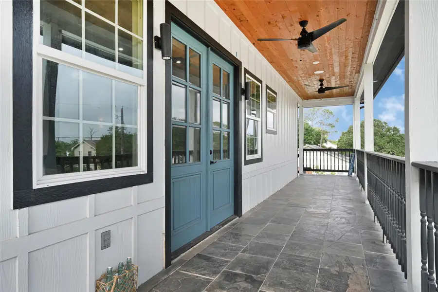 Expansive porch perfect for relaxing and entertaining, featuring sleek ceiling fans for comfort.