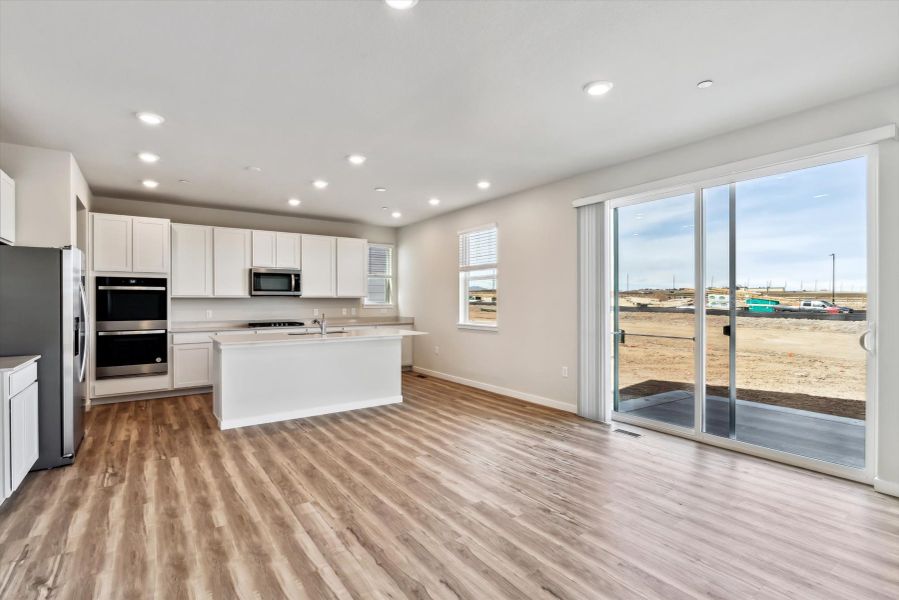 A kitchen with a large glass door.