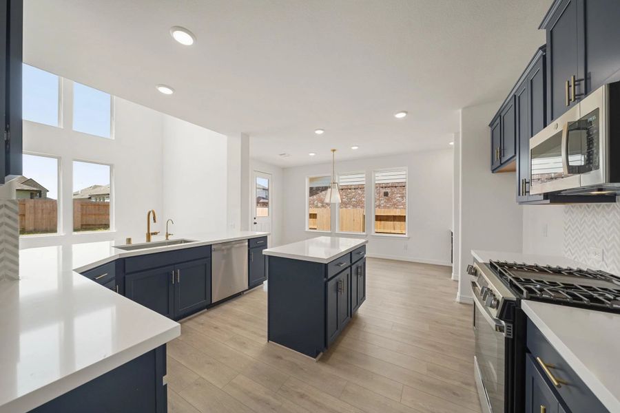 Kitchen and dining area. "Note: Sample product photo. Actual exterior and interior selections may vary by homesite. Photo may be virtually staged"