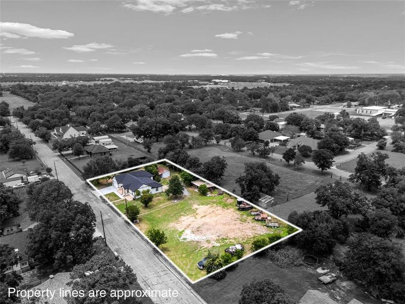 Aerial perspective showcasing a single-story residence with a dark roof Aerial perspective showcasing a single-story residence with a dark roof
