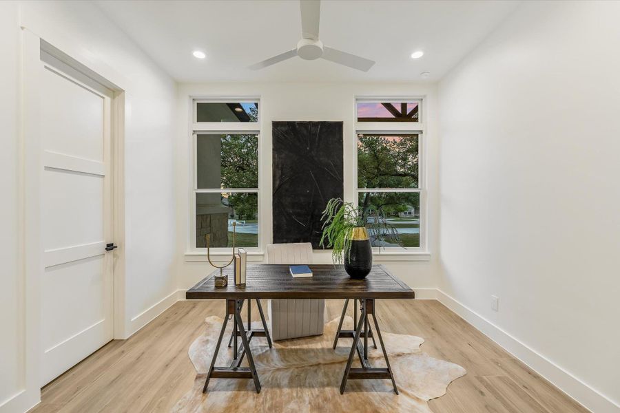 Office space featuring light wood finished floors, a ceiling fan, and recessed lighting