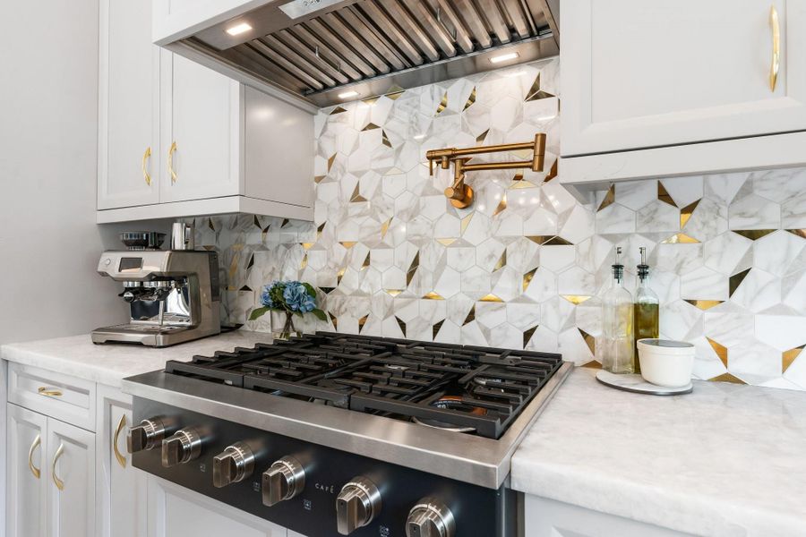 The back countertops are Cristallo White Quartzite a rare stone that compliments the stylish backsplash. The back countertops are Cristallo White Quartzite a rare stone that compliments the stylish backsplash.