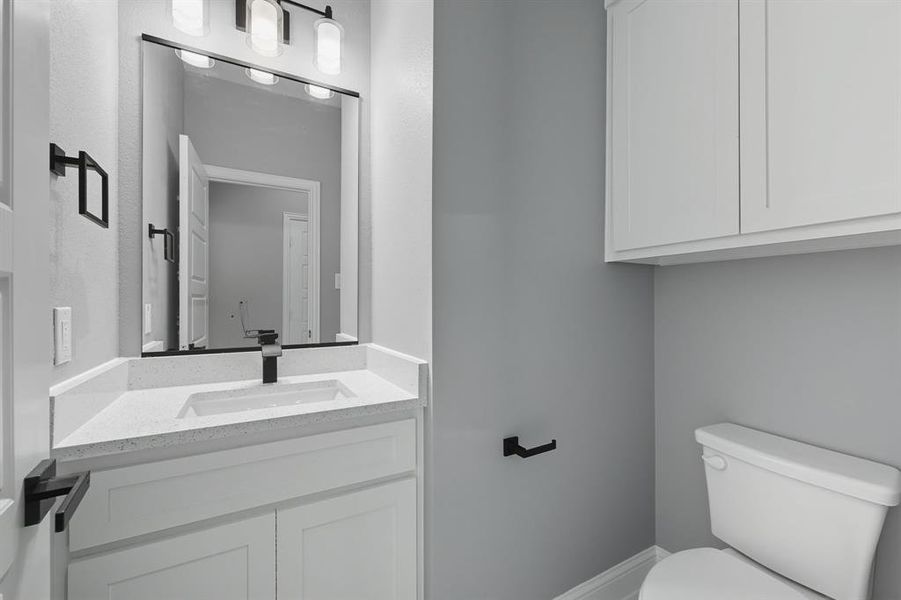 Half bathroom with vanity and toilet Half bathroom with vanity and toilet