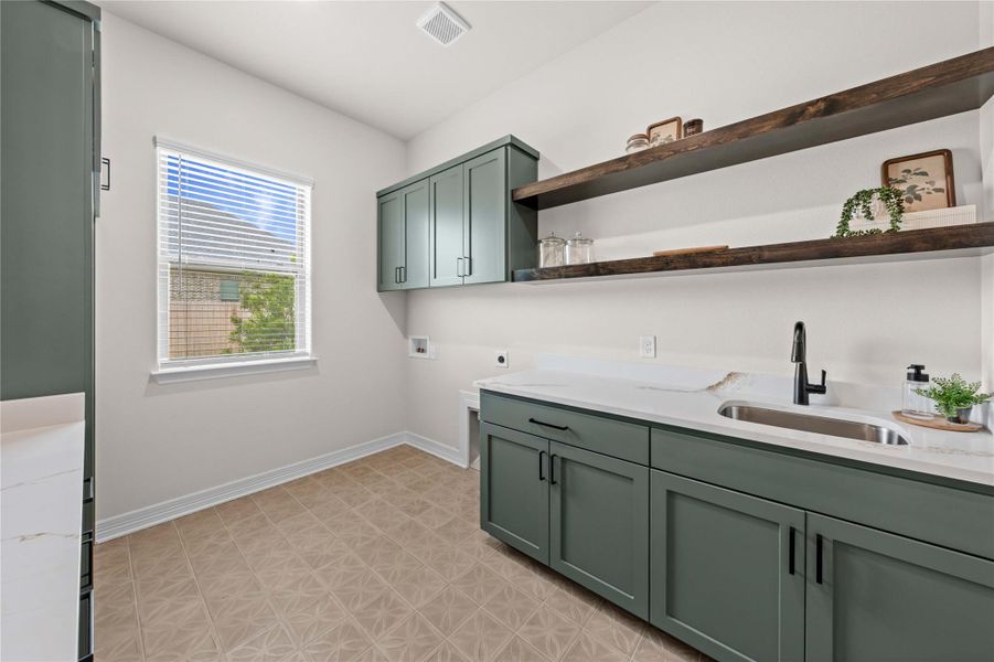 A well-appointed laundry room with a spacious sink and ample counter space for household tasks. A well-appointed laundry room with a spacious sink and ample counter space for household tasks.